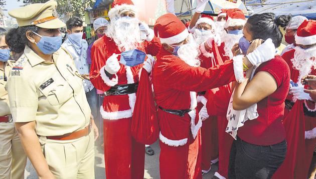 People dressed as Santa Claus help residents, who have ventured out without masks on Christmas, in Thane on Friday. (Praful Gangurde/HT photo) People dressed as Santa Claus help residents, who have ventured out without masks on Christmas, in Thane on Friday. (Praful Gangurde/HT photo)