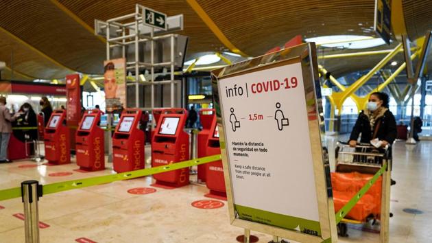 A Covid-19 information sign at the check-in area inside the departures hall at Madrid Barajas airport, operated by Aena SA, in Madrid, Spain. (Bloomberg)