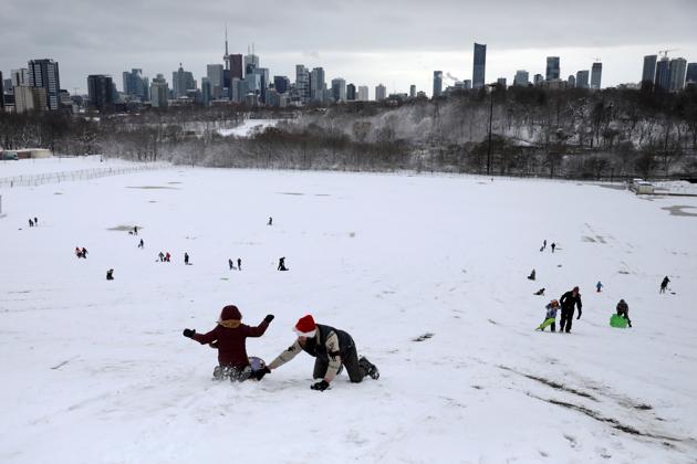 Families enjoy tobogganing during the fresh Christmas snowfall at Riverdale Park East in Toronto, Ontario, Canada. (REUTERS/Chris Helgren) Families enjoy tobogganing during the fresh Christmas snowfall at Riverdale Park East in Toronto, Ontario, Canada. (REUTERS/Chris Helgren)