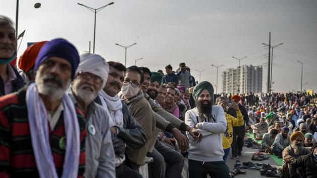 Farmers listen to a speaker as they block a major highway in a protest against new farm laws at the Delhi-Uttar Pradesh state border, India, Friday.(AP) Farmers listen to a speaker as they block a major highway in a protest against new farm laws at the Delhi-Uttar Pradesh state border, India, Friday.(AP)