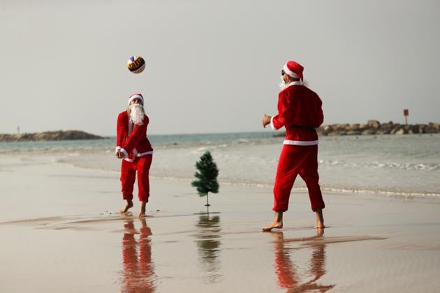 People dressed in Santa Claus costumes play a game of beach volleyball in an event organised by Tel Aviv Municipality ahead of Christmas, in Tel Aviv, Israel. (REUTERS/Ronen Zvulun) People dressed in Santa Claus costumes play a game of beach volleyball in an event organised by Tel Aviv Municipality ahead of Christmas, in Tel Aviv, Israel. (REUTERS/Ronen Zvulun)