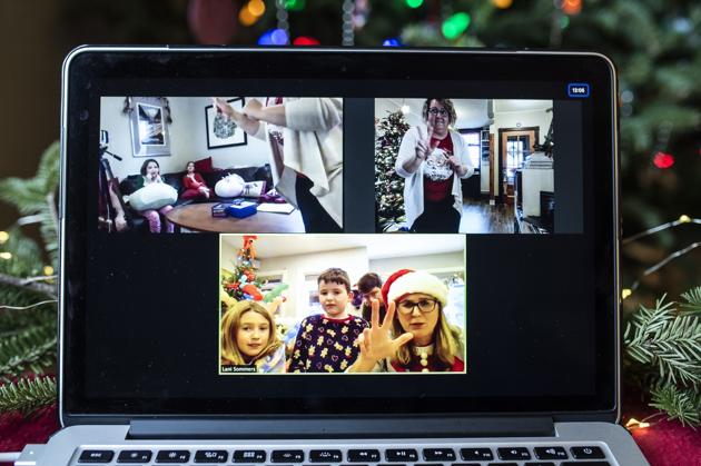 Neighbours and friends Valerie Gapp, top right, and Lani Sommers, bottom right, play a game of virtual charades with their families, both in Ottawa, Ontario seen through a video call on Christmas Day. Both families would normally spend the holiday hosting parties with neighbours or visiting with family from out of town. (AP Photo/Justin Tang) Neighbours and friends Valerie Gapp, top right, and Lani Sommers, bottom right, play a game of virtual charades with their families, both in Ottawa, Ontario seen through a video call on Christmas Day. Both families would normally spend the holiday hosting parties with neighbours or visiting with family from out of town. (AP Photo/Justin Tang)