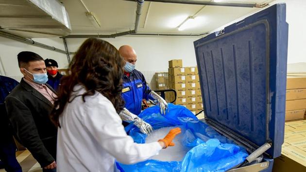 Vaccines are unpacked from under dry ice in a large box in the Clinical Pharmacy of the University of Debrecen in Debrecen, Hungary, after the first batch of the Pfizer-BioNTech vaccines against the new coronavirus arrived in the country. (AP) Vaccines are unpacked from under dry ice in a large box in the Clinical Pharmacy of the University of Debrecen in Debrecen, Hungary, after the first batch of the Pfizer-BioNTech vaccines against the new coronavirus arrived in the country. (AP)