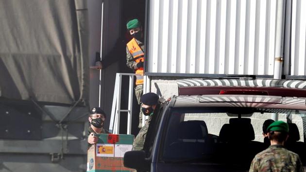 Boxes of Pfizer-BioNtech vaccines are loaded into a van for distribution, one day before the country starts its vaccination programme, at a warehouse in Cabanillas del Campo, Guadalajara, Spain. (Reuters)