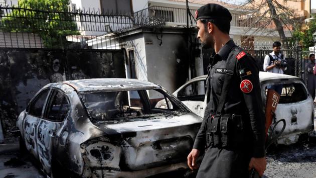 A paramilitary soldier walks past the wreckages of cars after an attack on the Chinese consulate, in Karachi, Pakistan. (REUTERS) A paramilitary soldier walks past the wreckages of cars after an attack on the Chinese consulate, in Karachi, Pakistan. (REUTERS)