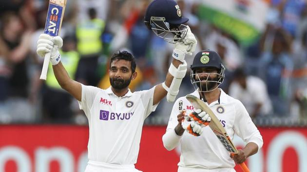 India's Ajinkya Rahane, left, celebrates after scoring a century as teammate Ravindra Jadeja watches during play on day two of the second cricket test between India and Australia at the Melbourne Cricket Ground.(AP)