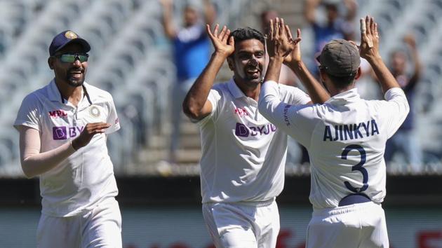 India's Ravichandran Ashwin, centre, celebrates with teammate Ajinkya Rahane, right, after dismissing Australia's Tim Paine during play on day one of the Boxing Day cricket test between India and Australia at the Melbourne Cricket Ground, Melbourne, Australia, Saturday, Dec. 26, 2020.(AP)