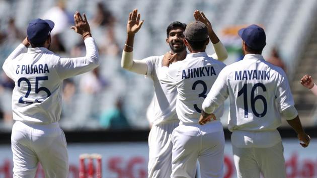 Melbourne : India's Jasprit Bumrah, centre, is congratulated by teammates after taking the wicket of Australia's Joe Burns for no score during play on day one of the Boxing Day cricket test between India and Australia at the Melbourne Cricket Ground, Melbourne, Australia, Saturday, Dec. 26, 2020.(AP)