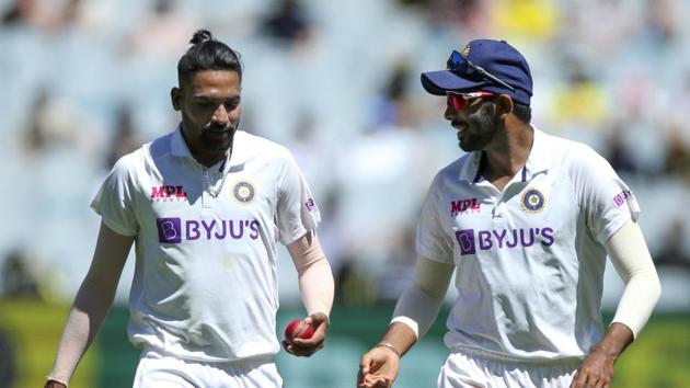 Melbourne : India's MD Siraj, left, and Jasprit Bumrah chat during play on day one of the Boxing Day cricket test between India and Australia at the Melbourne Cricket Ground, Melbourne, Australia, Saturday, Dec. 26, 2020.(AP)