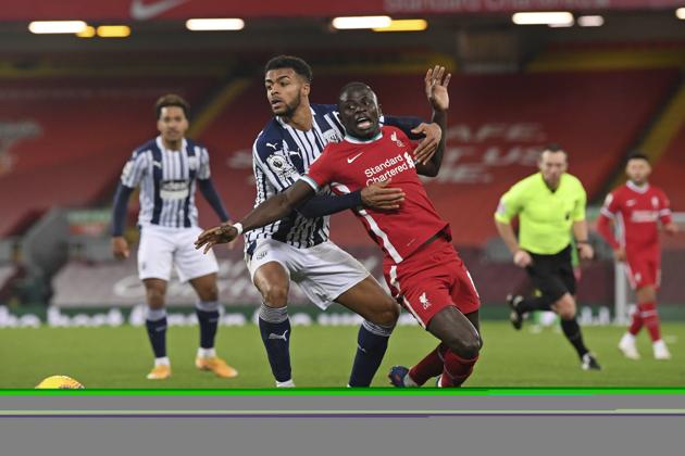 West Bromwich Albion's Darnell Furlong, left, challenges for the ball with Liverpool's Sadio Mane during an English Premier League soccer match between Liverpool and West Bromwich Albion at the Anfield stadium in Liverpool.(AP)