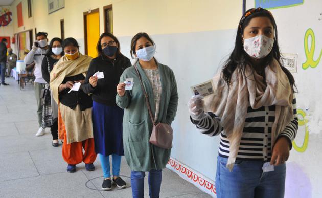 Women queue up at a polling booth at the Government Model Primary School in Sector-12-A, Panchkula, on Sunday.(Keshav Singh/HT)