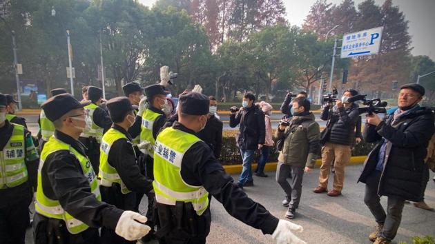 Police attempt to stop journalists from recording footage outside the Shanghai Pudong New District People's Court. (AFP) Police attempt to stop journalists from recording footage outside the Shanghai Pudong New District People's Court. (AFP)