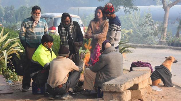 People warm themselves around a bonfire on a cold morning near Yamuna Bank metro station in New Delhi on December 27. A cold wave occurs in plains when the minimum temperature is 10 degrees Celsius or below and/or is 4.5 notches lesser than the season’s normal for two consecutive days. Cold wave is also declared when the minimum temperature is less than 4 degree Celsius in the plains. (Raj K Raj / HT Photo) People warm themselves around a bonfire on a cold morning near Yamuna Bank metro station in New Delhi on December 27. A cold wave occurs in plains when the minimum temperature is 10 degrees Celsius or below and/or is 4.5 notches lesser than the season’s normal for two consecutive days. Cold wave is also declared when the minimum temperature is less than 4 degree Celsius in the plains. (Raj K Raj / HT Photo)
