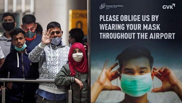 People wearing protective face masks wait for passengers to arrive at Chhatrapati Shivaji Maharaj International Airport after India cancelled all flights from the UK over fears of a new strain of the coronavirus disease (COVID-19), in Mumbai, India,.(REUTERS)