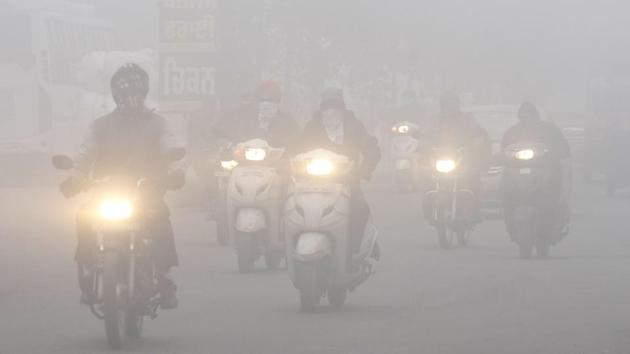 Motorists ply with their headlights on due to dense fog on a winter morning in Amritsar on December 26. Along with “cold wave” to “severe cold wave” and dense fog conditions over northwest India, IMD has predicted visibility under 50 metres in some parts of the region during this period. (Narinder Nanu / AFP) Motorists ply with their headlights on due to dense fog on a winter morning in Amritsar on December 26. Along with “cold wave” to “severe cold wave” and dense fog conditions over northwest India, IMD has predicted visibility under 50 metres in some parts of the region during this period. (Narinder Nanu / AFP)