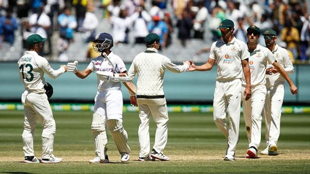 Ajinkya Rahane of India (2L) bumps fists with Matthew Wade of Australia as India win by 8 wickets.(Getty Images)