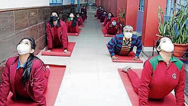 Students performing yoga on campus.(HT)