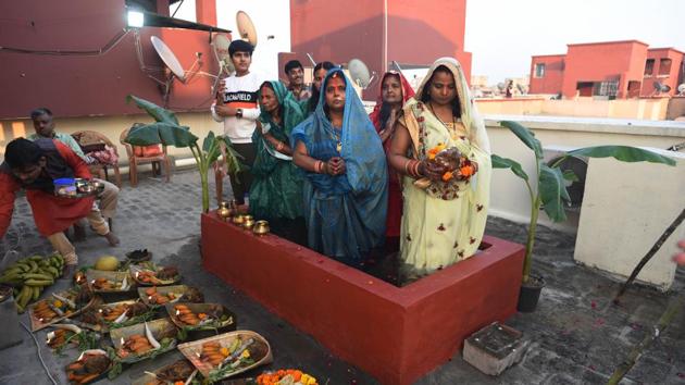 Festive observances this year were reshaped to the need of the hour, with low-key, personal observances outweighing mass gatherings. Here seen a family performing Chhath Puja on a makeshift pond on the roof of their house in New Delhi. (Vipin Kumar / HT Photo) Festive observances this year were reshaped to the need of the hour, with low-key, personal observances outweighing mass gatherings. Here seen a family performing Chhath Puja on a makeshift pond on the roof of their house in New Delhi. (Vipin Kumar / HT Photo)
