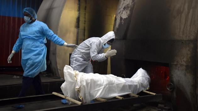 India crossed the grim 1 million cases mark on July 16 with over 25,000 deaths at the time. The contagious nature of the virus radically altered how those bereaved mourned their loved ones, in solemn ceremonies marked by PPE kits, as seen here at Nigambodh Ghat crematorium in New Delhi. (Sonu Mehta / HT Photo) India crossed the grim 1 million cases mark on July 16 with over 25,000 deaths at the time. The contagious nature of the virus radically altered how those bereaved mourned their loved ones, in solemn ceremonies marked by PPE kits, as seen here at Nigambodh Ghat crematorium in New Delhi. (Sonu Mehta / HT Photo)