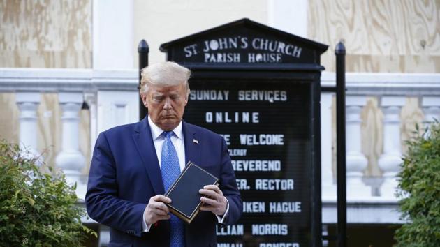 FILE - In this Monday, June 1, 2020 file photo, President Donald Trump holds a Bible during a visit outside St. John's Church across Lafayette Park from the White House in Washington. (AP Photo/Patrick Semansky)