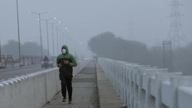 A man wearing face mask as a precaution against the coronavirus jogs on a cold and foggy morning in Jammu on December 28. The health ministry also said on December 28 that India’s Covid-19 cases per million population are among the lowest in the world (7,397) while the global average is 10,149. (Channi Anand / AP) A man wearing face mask as a precaution against the coronavirus jogs on a cold and foggy morning in Jammu on December 28. The health ministry also said on December 28 that India’s Covid-19 cases per million population are among the lowest in the world (7,397) while the global average is 10,149. (Channi Anand / AP)