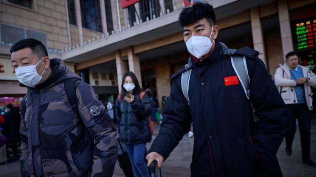 Travellers wearing face masks push suitcases outside Beijing Railway Station following an outbreak of the coronavirus disease (COVID-19) in Beijing, China.(REUTERS) Travellers wearing face masks push suitcases outside Beijing Railway Station following an outbreak of the coronavirus disease (COVID-19) in Beijing, China.(REUTERS)