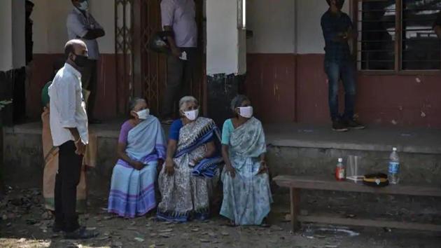 Elderly women wearing masks as a precaution against the coronavirus wait to vote for local body elections in Kochi, Kerala.(AP) Elderly women wearing masks as a precaution against the coronavirus wait to vote for local body elections in Kochi, Kerala.(AP)