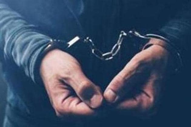 Arrested computer hacker and cyber criminal with handcuffs, close up of hands(Getty Images/iStockphoto)