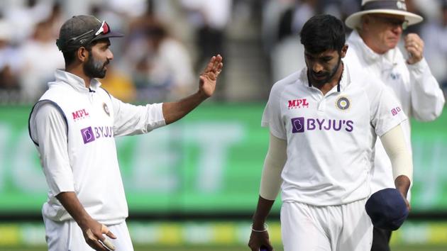 India's Ajinkya Rahane, left, talks with his bowler Jasprit Bumrah during play on day three of the second cricket test between India and Australia at the Melbourne Cricket Ground.(AP)