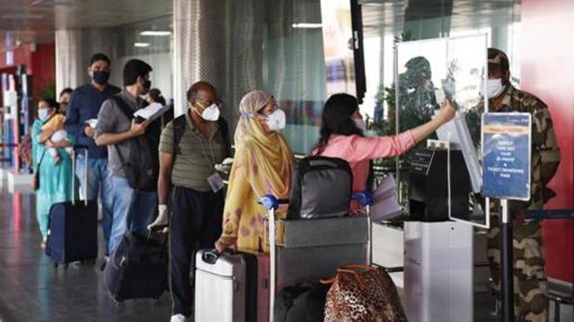 Travellers show their IDs while maintaining social distancing at an entry gate at Terminal T2 of Indira Gandhi International (IGI) Airport . (Vipin Kumar/HT PHOTO) Travellers show their IDs while maintaining social distancing at an entry gate at Terminal T2 of Indira Gandhi International (IGI) Airport . (Vipin Kumar/HT PHOTO)