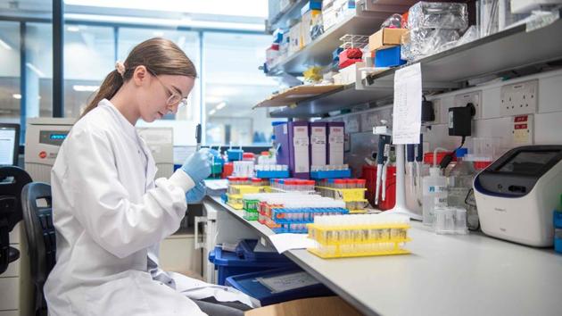 A technician works on the Oxford University's Covid-19 candidate vaccine, known as AZD1222, co-invented by the University of Oxford and Vaccitech in partnership with pharmaceutical giant AstraZeneca.(AFP file)