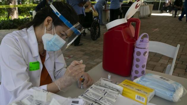 A healthcare worker prepares to administer a dose of the Pfizer-BioNTech Covid-19 vaccine in Miami. (Bloomberg) A healthcare worker prepares to administer a dose of the Pfizer-BioNTech Covid-19 vaccine in Miami. (Bloomberg)