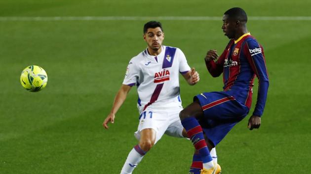 Eibar's Rafa Soares, left, challenges Barcelona's Ousmane Dembele during the Spanish La Liga soccer match between Barcelona and Eibar at the Camp Nou stadium in Barcelona.(AP)