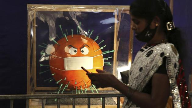 A woman walks past a cake depicting the coronavirus during the annual cake show in Bengaluru on December 29. Out the 20 people who have tested positive for the UK variant, some are identified from Karnataka (7), Delhi (4), Tamil Nadu (1), Telangana (1), Andhra Pradesh (1), Uttar Pradesh (1) and West Bengal (1). (Aijaz Rahi / AP) A woman walks past a cake depicting the coronavirus during the annual cake show in Bengaluru on December 29. Out the 20 people who have tested positive for the UK variant, some are identified from Karnataka (7), Delhi (4), Tamil Nadu (1), Telangana (1), Andhra Pradesh (1), Uttar Pradesh (1) and West Bengal (1). (Aijaz Rahi / AP)