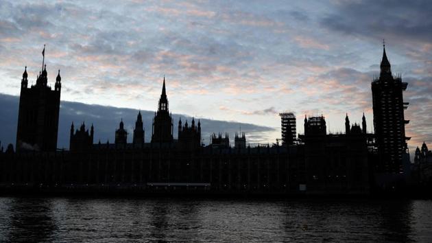 The Sun sets behind the Houses of Parliament in central London on December 30, 2020.