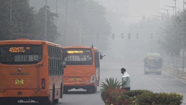 A man waits for buses to pass before crossing a road on a foggy morning, at Lodhi Road in New Delhi. (Biplov Bhuyan/HT PHOTO) A man waits for buses to pass before crossing a road on a foggy morning, at Lodhi Road in New Delhi. (Biplov Bhuyan/HT PHOTO)