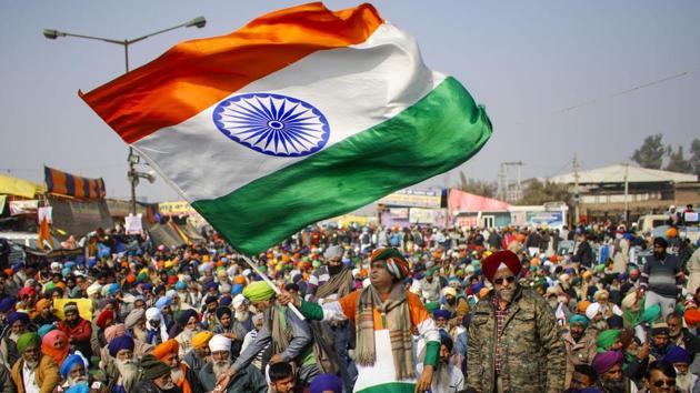 A farmer holds the Tricolor during a protest against the new farm laws, at Singhu Border in New Delhi.(PTI) A farmer holds the Tricolor during a protest against the new farm laws, at Singhu Border in New Delhi.(PTI)