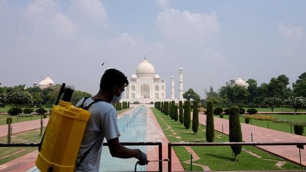 A man sanitizes railings in the premises of Taj Mahal after authorities reopened the monument to visitors, amidst the coronavirus disease (Covid-19) outbreak, in Agra, India.(REUTERS)