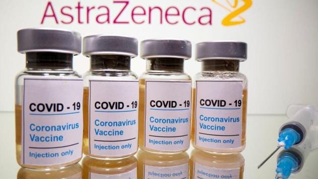 Vials with a sticker reading, "Covid-19 / Coronavirus vaccine / Injection only" and a medical syringe are seen in front of a displayed AstraZeneca logo in this illustration.(File Photo / REUTERS)