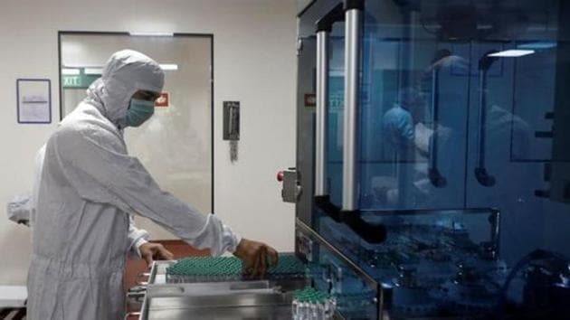 An employee in PPE removes vials of AstraZeneca's Covishield inside a lab at Serum Institute of India, in Pune, India.(REUTERS) An employee in PPE removes vials of AstraZeneca's Covishield inside a lab at Serum Institute of India, in Pune, India.(REUTERS)
