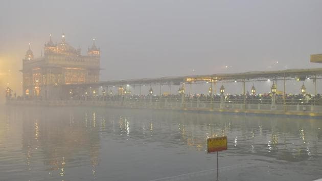 Devotees queue at the Golden Temple on New Year’s Day amid dense fog in Amritsar on January 1. Sikar and Pilani in east Rajasthan also recorded 0°C and 0.2°C respectively on December 31 while Churu in west Rajasthan recorded -1.3°C. Pantnagar in Uttarakhand, Una in Himachal Pradesh recorded 0.1°C and 0.5°C, respectively. (Sameer Sehgal / HT Photo)