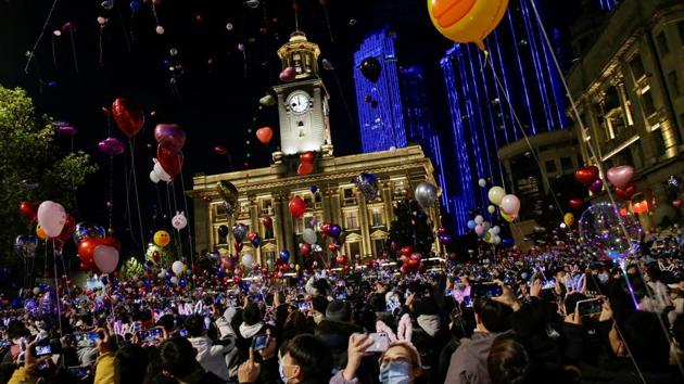 People gather to celebrate the arrival of the new year in Wuhan, China on December 31. In Wuhan, where the virus originated in late in 2019, much appeared to have gone back to a normal most nations didn’t recognise. (Tingshu Wang / REUTERS)