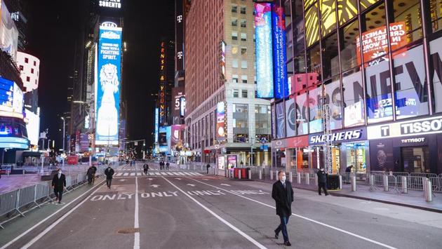 Times Square missing its jubilant crowds ahead of a virtual New Year’s Eve celebrations in New York on December 31. The annual New Year's Eve ball drop event, which typically draws more than 1 million people, was closed to the public to avoid the risk of Covid-19 virus contagion. (Angus Mordant / Bloomberg)