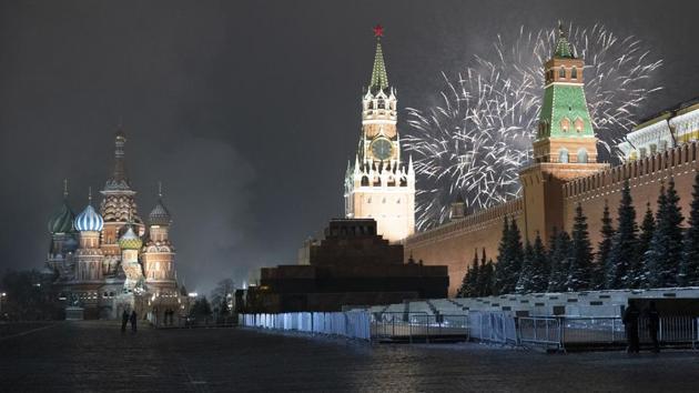 Fireworks explode over the Kremlin and almost empty Red Square during New Year's celebrations with the St. Basil's Cathedral (L), and the Spasskaya Tower , in Moscow, Russia on January 1. (Pavel Golovkin / AP)