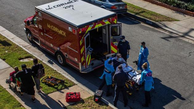 County of Los Angeles paramedics load a potential Covid-19 patient in an ambulance before transporting him to a hospital in Hawthorne, California as a family walks by on December 29. Hospitals, particulary in Southern California, have run out of intensive-care unit (ICU) beds, Bloomberg reported. The 12.2% test positivity rate is at one of the highest levels since the start of the pandemic. (Apu Gomes / AFP) County of Los Angeles paramedics load a potential Covid-19 patient in an ambulance before transporting him to a hospital in Hawthorne, California as a family walks by on December 29. Hospitals, particulary in Southern California, have run out of intensive-care unit (ICU) beds, Bloomberg reported. The 12.2% test positivity rate is at one of the highest levels since the start of the pandemic. (Apu Gomes / AFP)