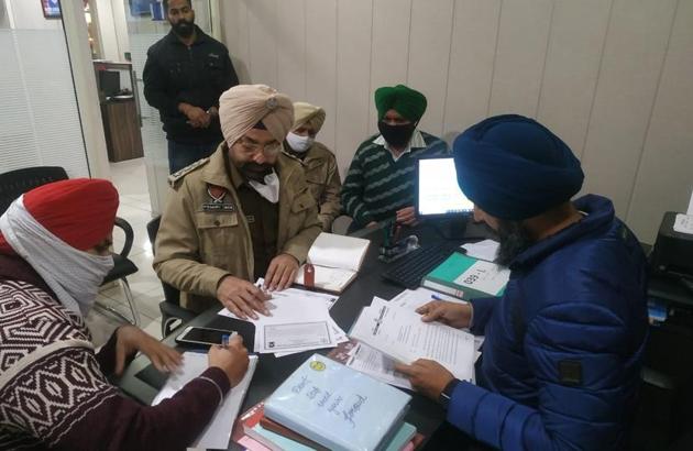 Police personnel during raids at travel agent offices in Ludhiana on Friday. (Harsimar Pal Singh/HT) Police personnel during raids at travel agent offices in Ludhiana on Friday. (Harsimar Pal Singh/HT)