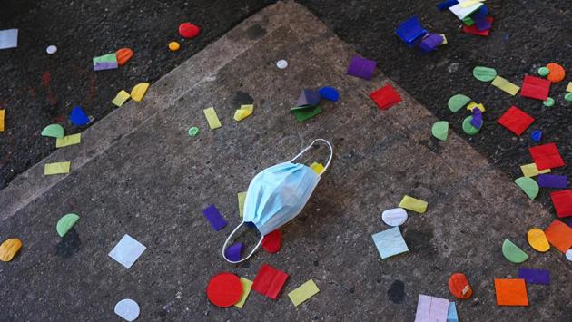 A discarded protective mask on the ground next to confetti in Times Square following New Year’s Eve celebrations in New York on January 1. The desperate race to vaccinate is set to dominate the coming year, with the coronavirus already having killed at least 1.8 million people since emerging in China in December 2019, according to a tally by AFP. (Angus Mordant / Bloomberg) A discarded protective mask on the ground next to confetti in Times Square following New Year’s Eve celebrations in New York on January 1. The desperate race to vaccinate is set to dominate the coming year, with the coronavirus already having killed at least 1.8 million people since emerging in China in December 2019, according to a tally by AFP. (Angus Mordant / Bloomberg)
