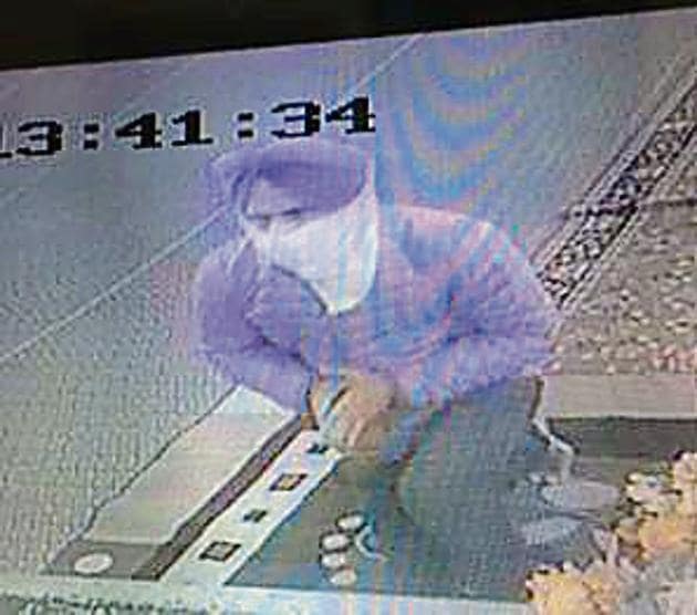 A CCTV grab showing the miscreant executing the crime. (HT PHOTO) A CCTV grab showing the miscreant executing the crime. (HT PHOTO)