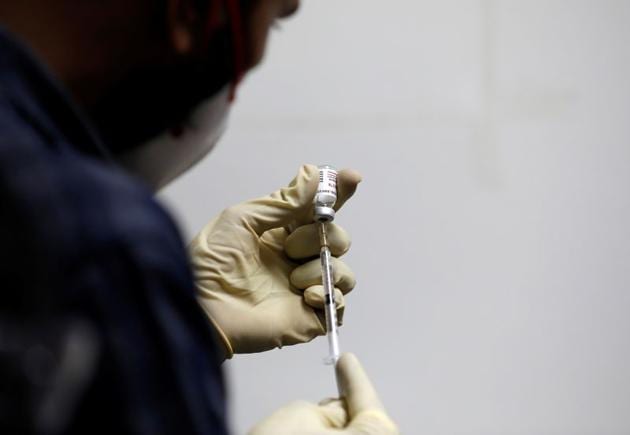 A medic fills a syringe with Covaxin, a government-backed experimental Covid-19 vaccine, before administering it to a health worker during its trials.(Reuters File Photo)