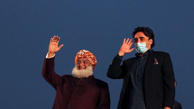 Pakistani politician Maulana Fazlur Rehman and Bilawal Bhutto Zardari, chairman of the Pakistan Peoples Party (PPP), wave to the supporters during an anti-government protest rally organized by the Pakistan Democratic Movement (PDM), an alliance of political opposition parties, in Lahore, Pakistan.(REUTERS)